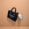 CHARES PARIS black handbag with white logo, black leather handle and beige sofa scene Application Scenario